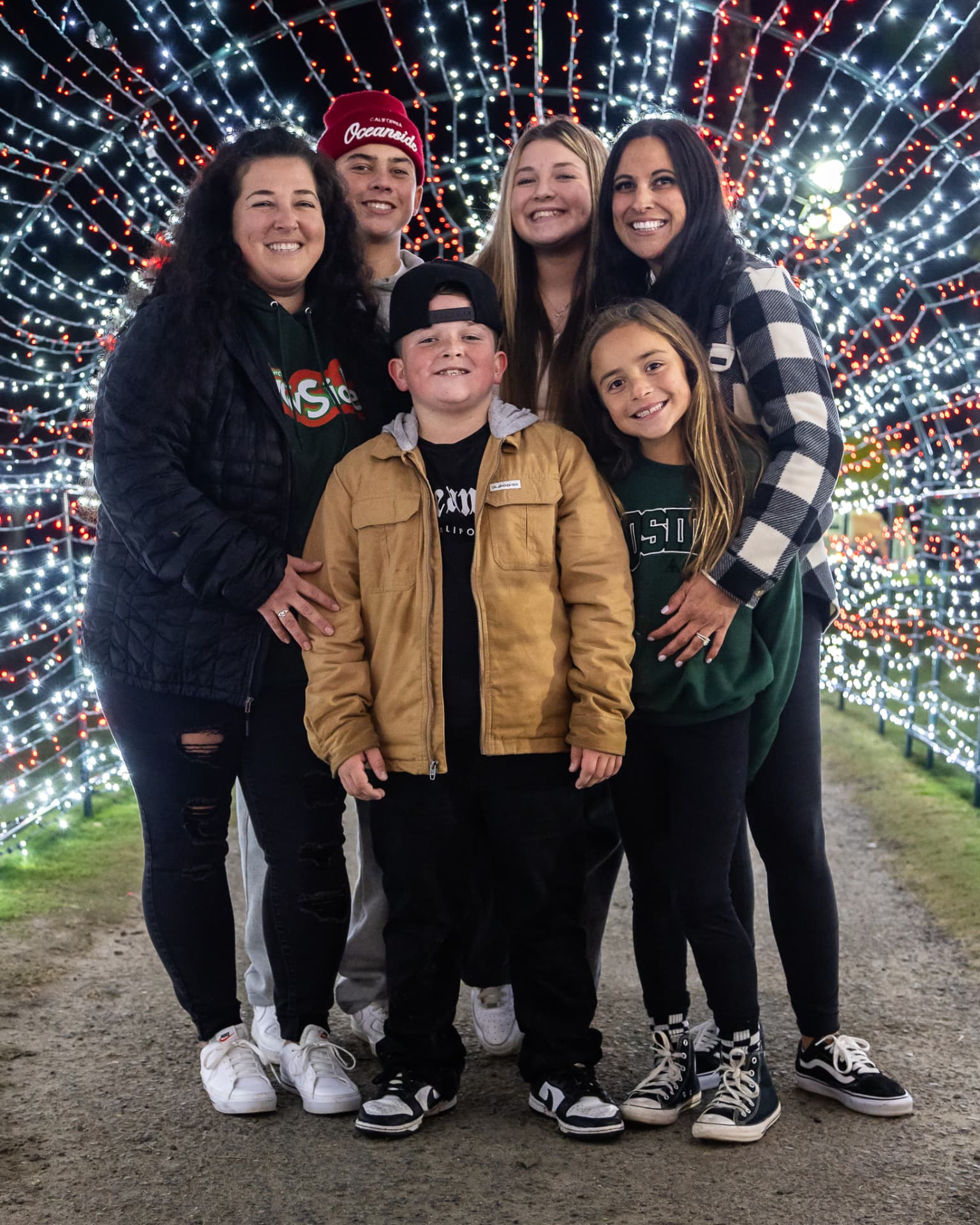 Family of five inside the red and white light tunnel