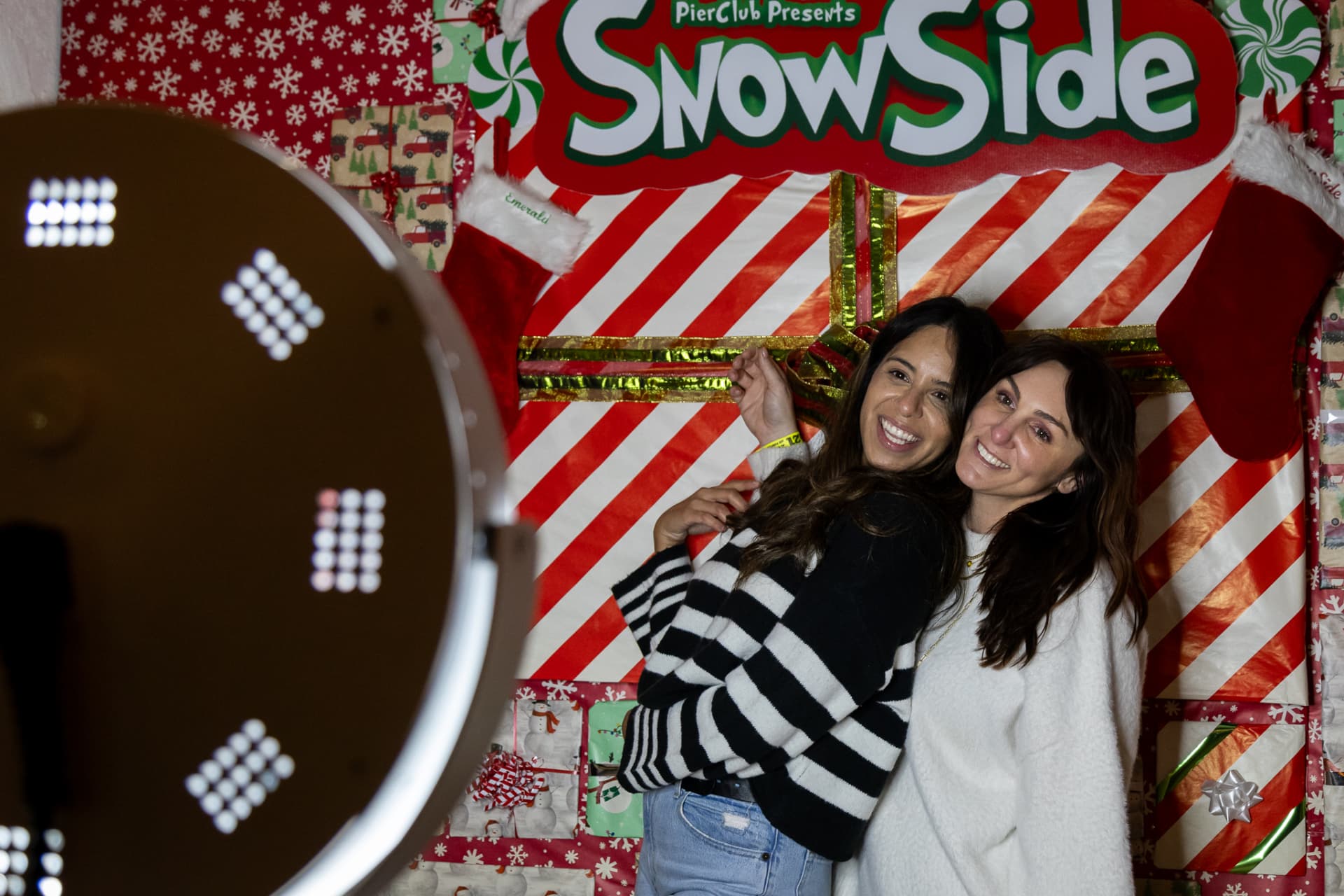 Friends at the SnowSide photo booth backdrop